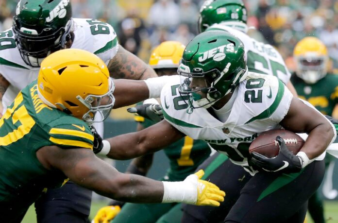 Green Bay Packers defensive tackle Kenny Clark (97) tackles New York Jets running back Breece Hall (20) during their football game on Sunday, October 16, 2022 at Lambeau Field in Green Bay, Wis.