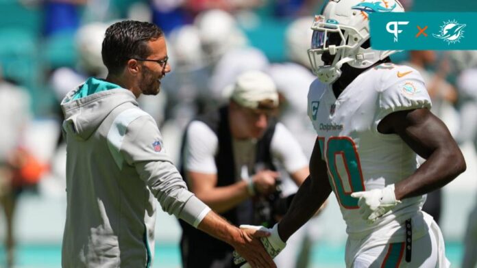 Miami Dolphins head coach Mike McDaniel and wide receiver Tyreek Hill shaking hands.