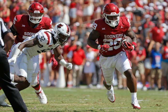 Oklahoma's Tawee Walker (29) runs past Arkansas State's Thurman Geathers (92) during a college football game between the University of Oklahoma Sooners (OU) and the Arkansas State Red Wolves at Gaylord Family-Oklahoma Memorial Stadium in Norman, Okla., Saturday, Sept. 2, 2023. Oklahoma