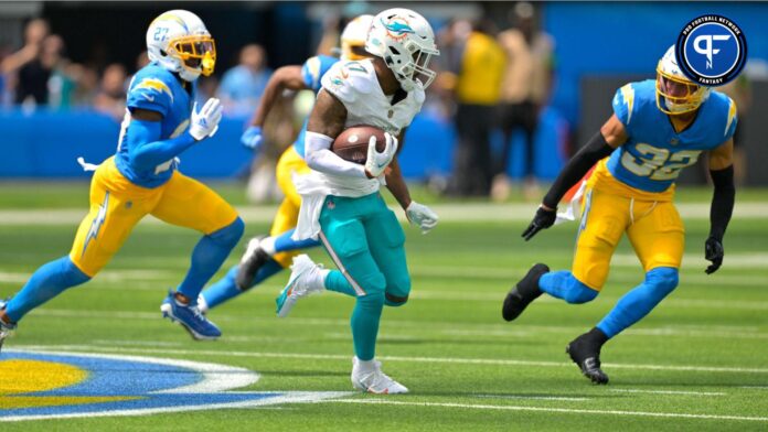 Miami Dolphins wide receiver Jaylen Waddle (17) is chased down by Los Angeles Chargers cornerback J.C. Jackson (27) and safety Alohi Gilman (32) after a pass play in the first half at SoFi Stadium.