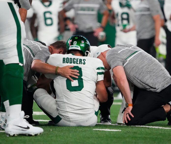 New York Jets quarterback Aaron Rodgers (8) is injured after a sack by Buffalo Bills defensive end.