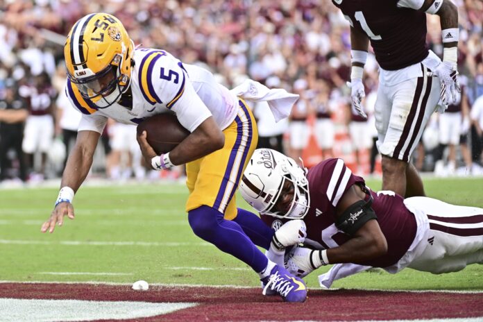 LSU Tigers QB Jayden Daniels (5) rushes into the end zone against the Mississippi State Bulldogs.