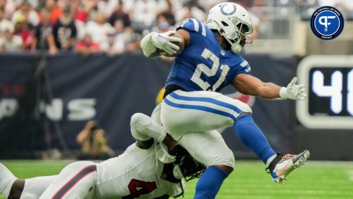 A top Week 3 waiver wire target, Zack Moss evades a tackle.