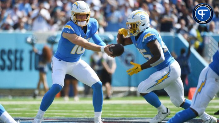 Los Angeles Chargers quarterback Justin Herbert (10) hands the ball off to running back Joshua Kelley (25) during the first half against the Tennessee Titans at Nissan Stadium.