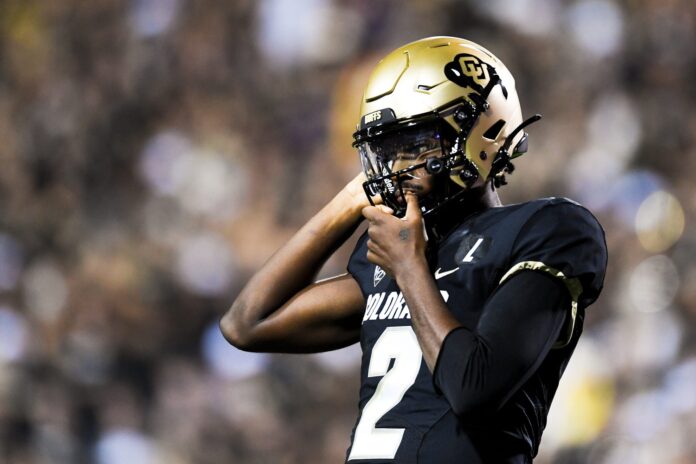 Shedeur Sanders (2) tightens his helmet during a college football game against Colorado State at Folsom Field.