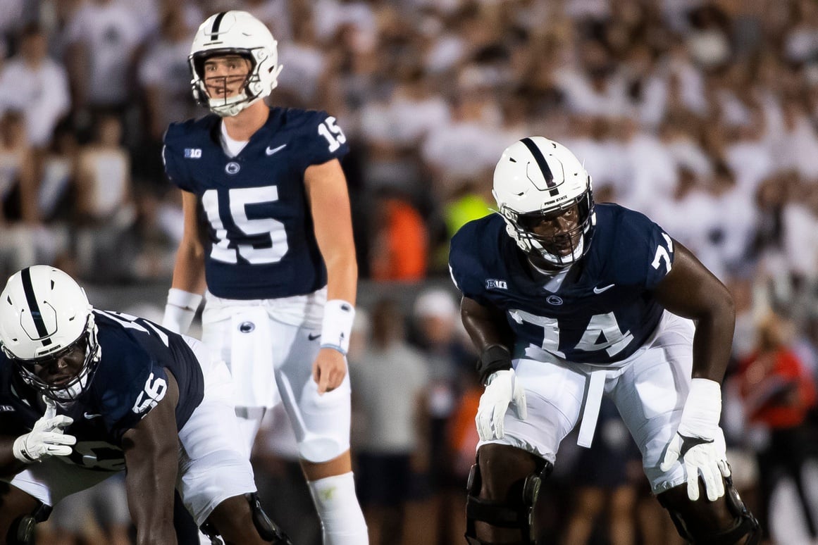 Olu Fashanu (74) gets set before a play against West Virginia at Beaver Stadium.