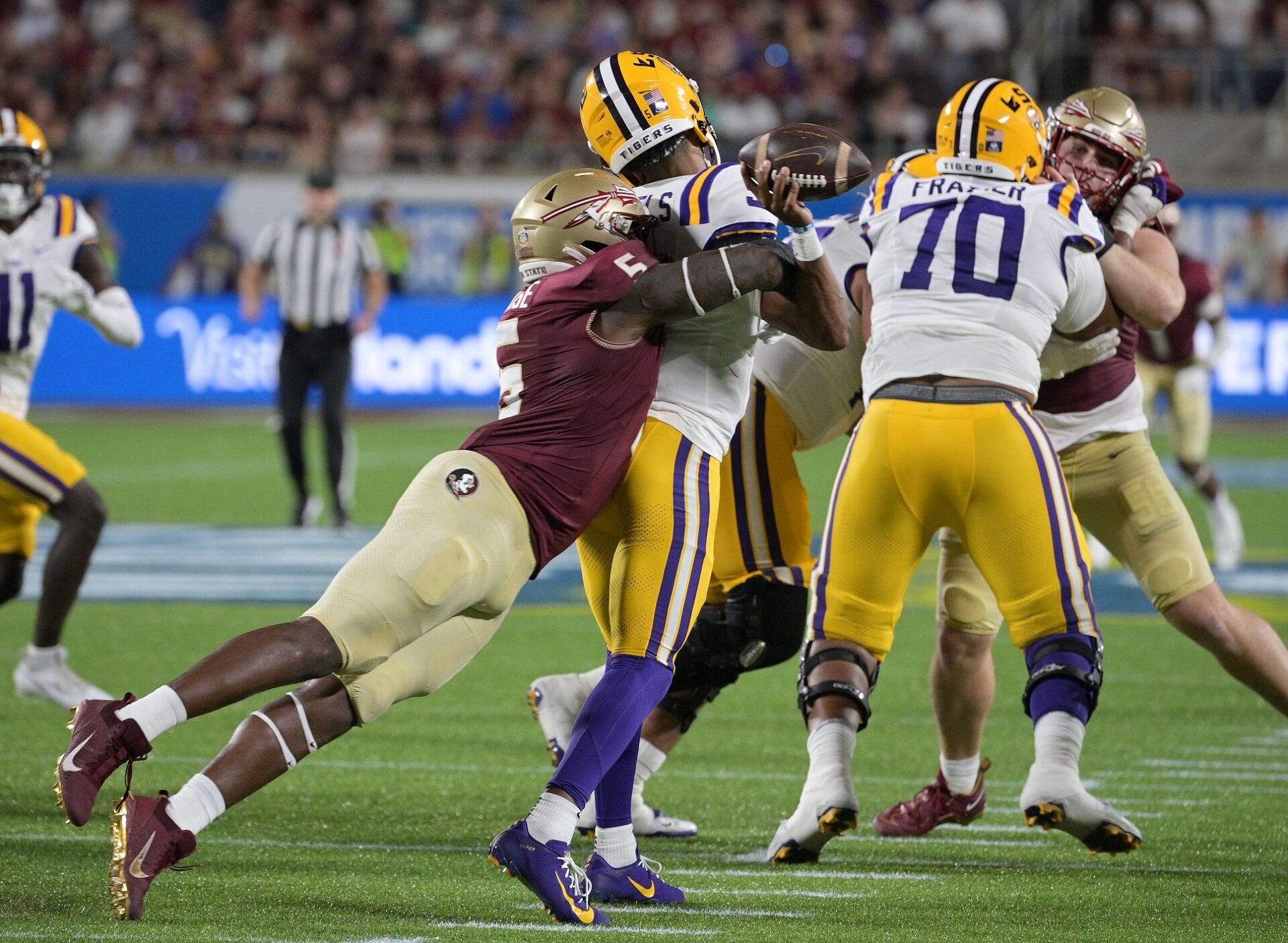 LSU Tigers quarterback Jayden Daniels (5) is sacked by Florida State Seminoles defensive end Jared Verse (5) during the game at Camping World Stadium.