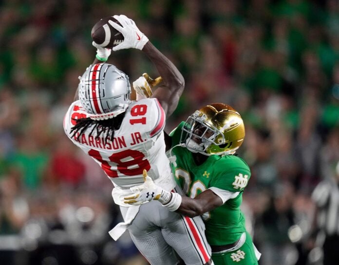Sep 23, 2023; South Bend, Indiana, USA; Ohio State Buckeyes wide receiver Marvin Harrison Jr. (18) tries to come up with the catch against Notre Dame Fighting Irish cornerback Benjamin Morrison (20) but draws a penalty during the second quarter of their game at Notre Dame Stadium.
