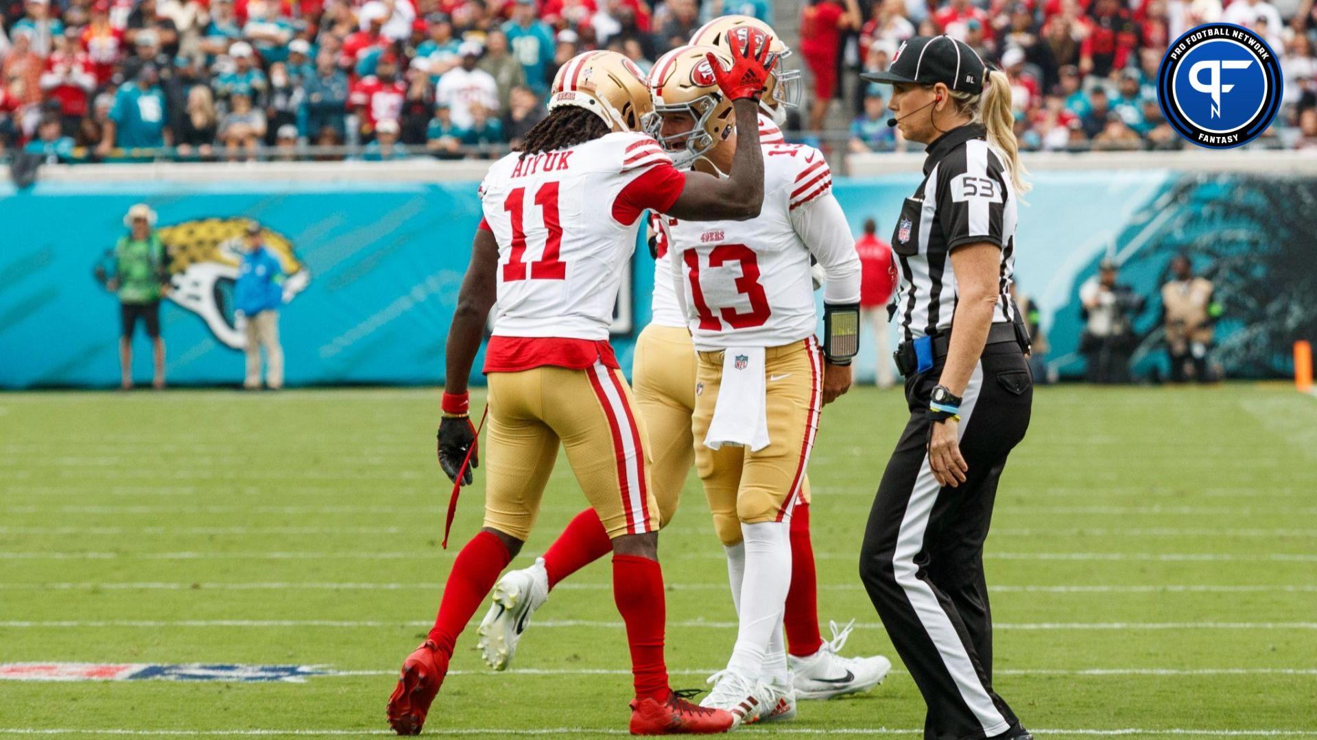 San Francisco 49ers wide receiver Brandon Aiyuk (11) and quarterback Brock Purdy (13) celebrate a touchdown against the Jacksonville Jaguars during the first quarter at EverBank Stadium.