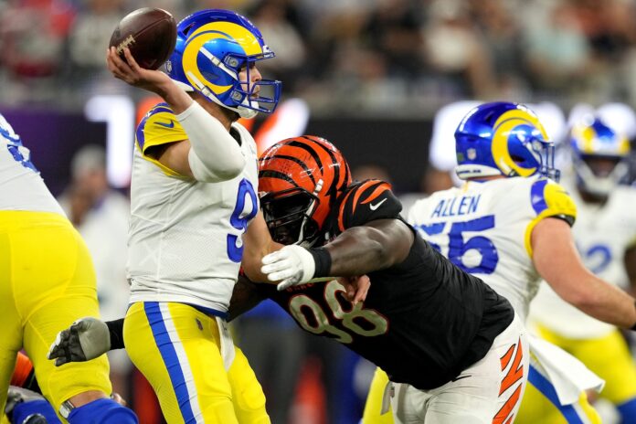 Matthew Stafford (9) is hit as he throws by Cincinnati Bengals nose tackle D.J. Reader (98) in the third quarter during Super Bowl 56.