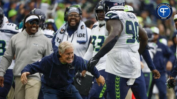 Seattle Seahawks head coach Pete Carroll celebrates a sack by defensive tackle Jarran Reed (90) during the fourth quarter against the Carolina Panthers at Lumen Field.