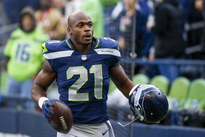 Seattle Seahawks RB Adrian Peterson (21) on the sidelines during a game.