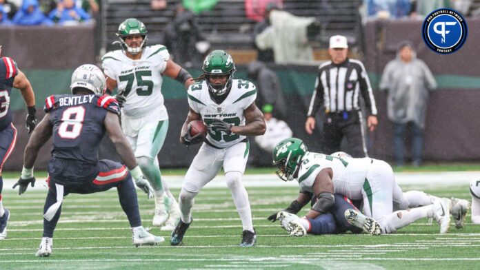 New York Jets running back Dalvin Cook (33) carries the ball asNew England Patriots linebacker Ja'Whaun Bentley (8) defends during the second half at MetLife Stadium.