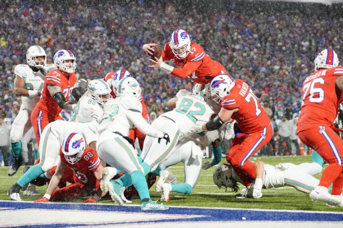 Josh Allen (17) dives for a two point conversion against the Miami Dolphins during the second half at Highmark Stadium.