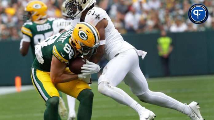 Green Bay Packers tight end Luke Musgrave (88) gets a first down reception against New Orleans Saints safety Jordan Howden (31) in the third quarter during their football game Sunday, September 24, 2023, at Lambeau Field in Green Bay, Wis.
