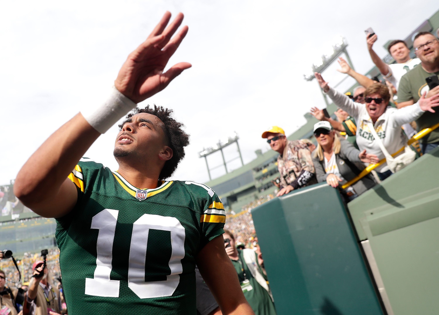 Green Bay Packers quarterback waves to fans after beating the New Orleans Saints.