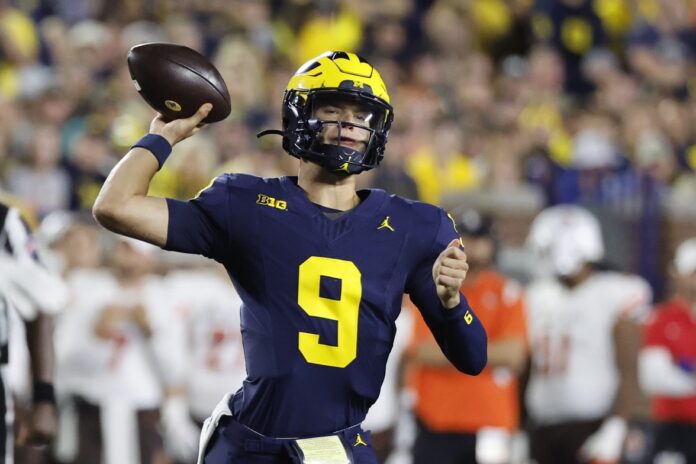 J.J. McCarthy (9) throws against the Bowling Green Falcons in the first half at Michigan Stadium.