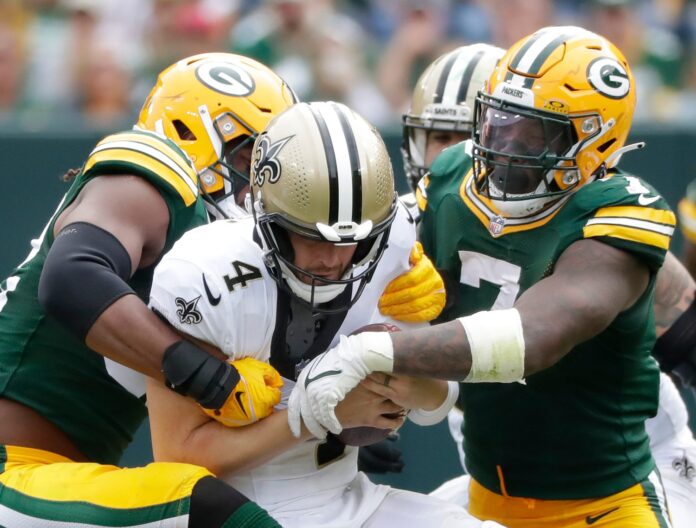 Green Bay Packers linebacker Rashan Gary (52) and linebacker Quay Walker (7) sack New Orleans Saints quarterback Derek Carr (4) during their football game Sunday, September 24, 2023, at Lambeau Field in Green Bay, Wis. The Packers defeated the Saints 18-17.