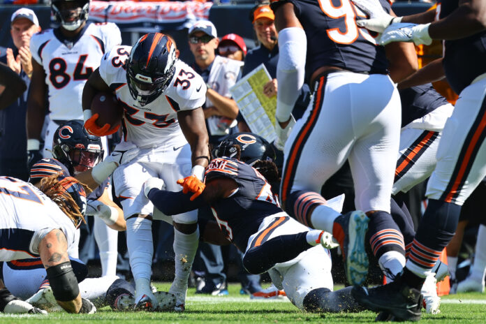 Denver Broncos RB Javonte Williams (33) rushes the ball against the Chicago Bears.
