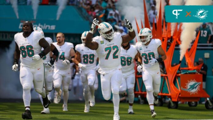 Terron Armstead (72) leads the team onto the field before a game against the Denver Broncos at Hard Rock Stadium.