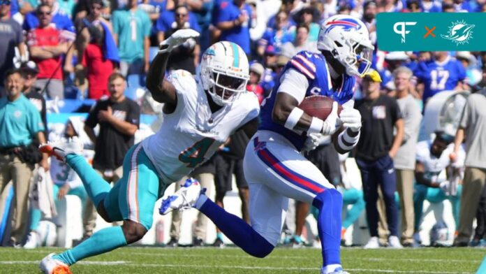 Buffalo Bills wide receiver Stefon Diggs (14) runs with the ball after making a catch against Miami Dolphins cornerback Kader Kohou (4) during the first half at Highmark Stadium.