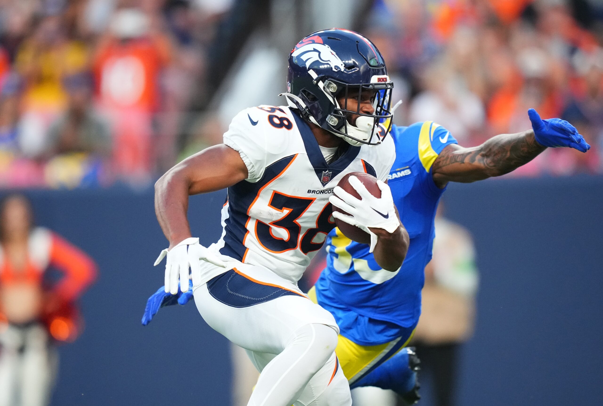 Jaleel McLaughlin (38) carries for a touchdown in the first quarter against the Los Angeles Rams at Empower Field at Mile High.