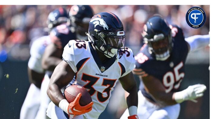 Oct 1, 2023; Chicago, Illinois, USA; Denver Broncos running back Javonte Williams (33) looks for running room in the first quarter against the Chicago Bears at Soldier Field.