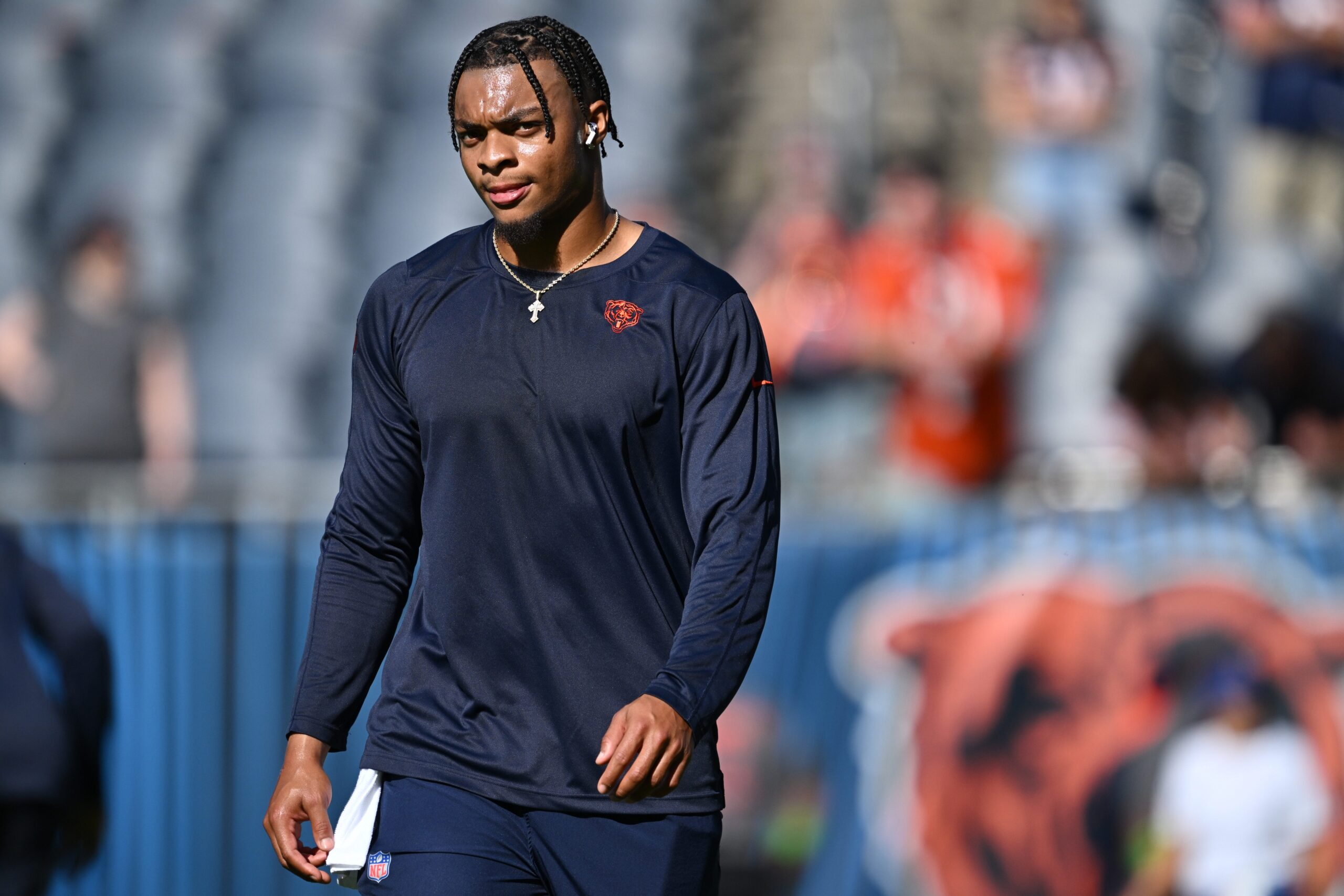 A Chicago Bears fan holds a quarterback Justin Fields jersey