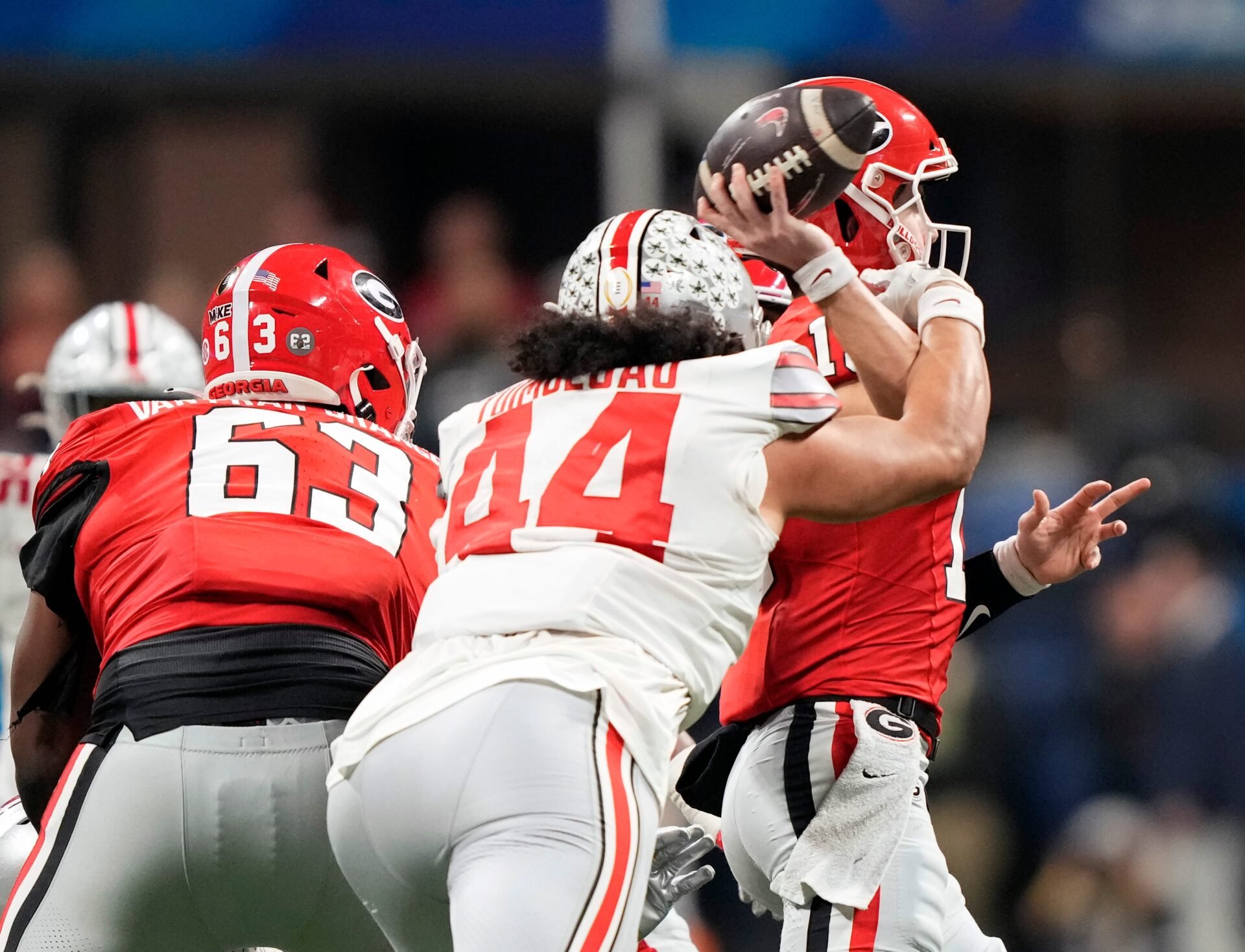 Ohio State Buckeyes defensive end J.T. Tuimoloau (44) hits the arm of Georgia Bulldogs quarterback Stetson Bennett (13) as the throws the ball in the third quarter during the Peach Bowl in the College Football Playoff semifinal at Mercedes-Benz Stadium.