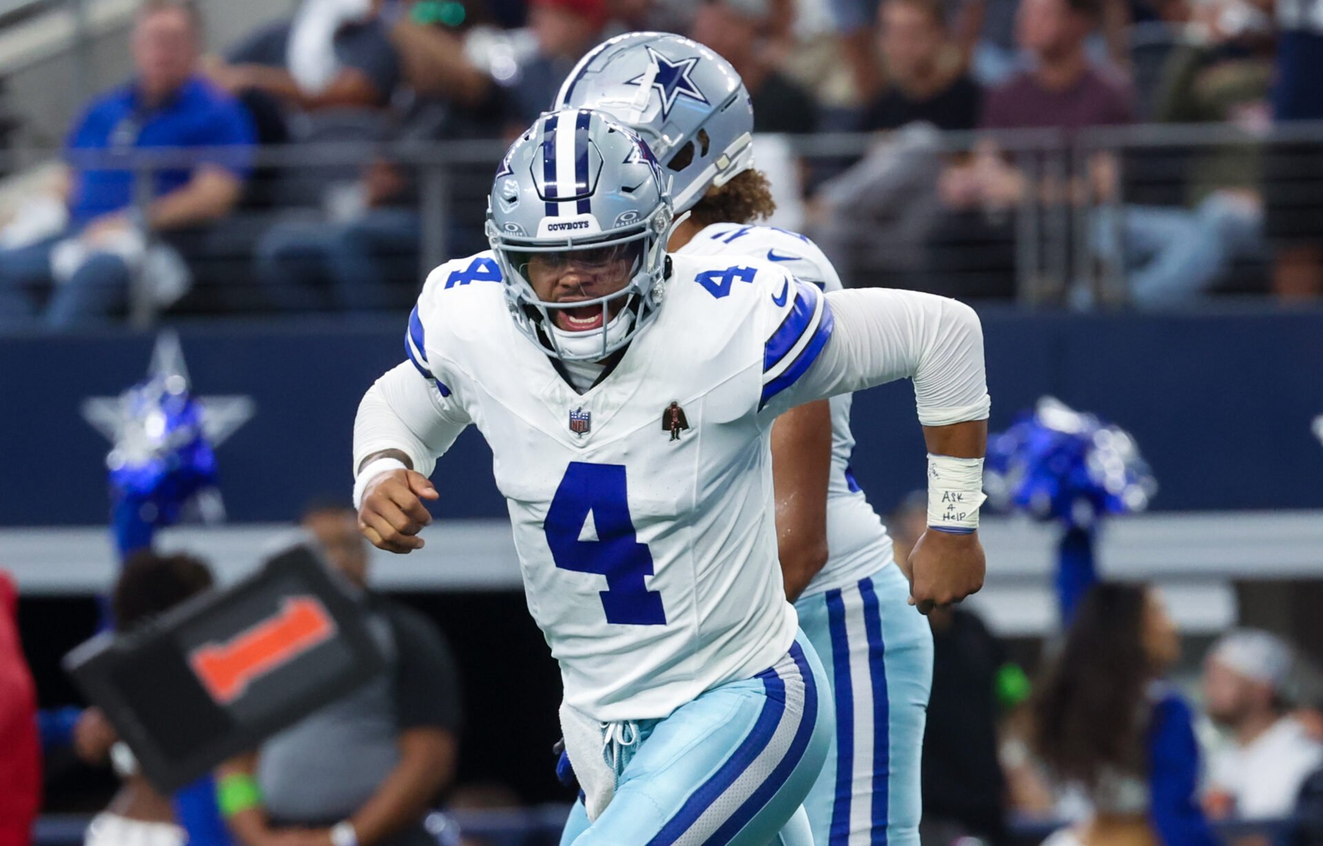 Dallas Cowboys quarterback Dak Prescott (4) celebrates after throwing a touchdown pass during the first quarter against the New England Patriots at AT&T Stadium.