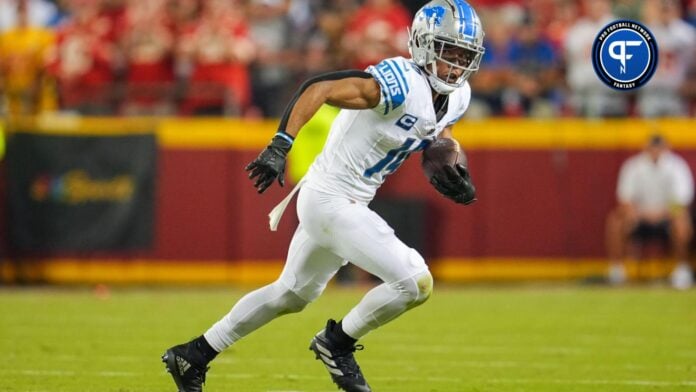 Amon-Ra St. Brown of the Detroit Lions runs with the ball as