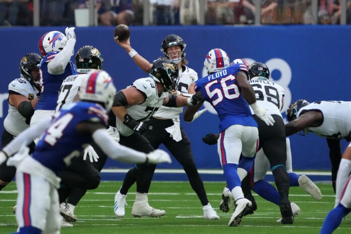 Jacksonville Jaguars quarterback Trevor Lawrence (16) looks for a