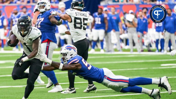 Jacksonville Jaguars running back Travis Etienne Jr. (1) escapes a tackle from Buffalo Bills defensive end Leonard Floyd (56) during the second half of an NFL International Series game.