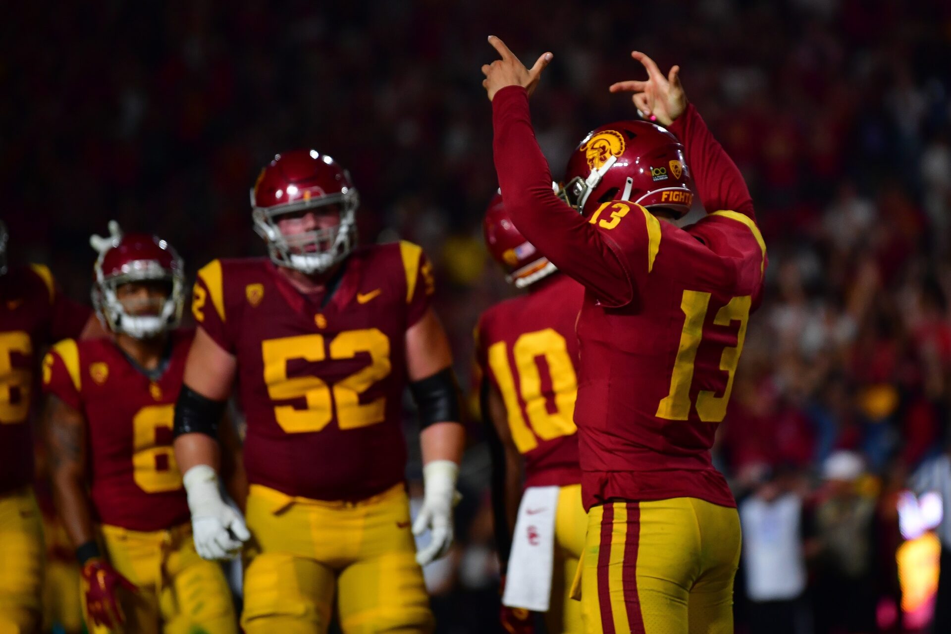 Caleb Williams (13) celebrates after scoring the two point conversion against the Arizona Wildcats during the third overtime at Los Angeles Memorial Coliseum.