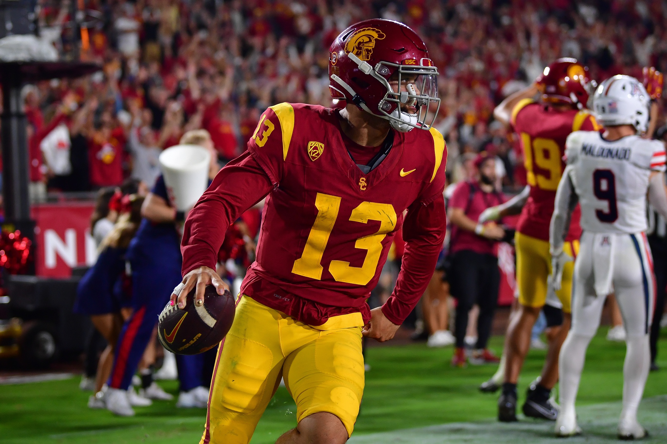 Caleb Williams (13) scores on the two point conversion against the Arizona Wildcats during the third overtime at Los Angeles Memorial Coliseum.