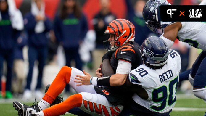 Joe Burrow (9) is sacked by Seattle Seahawks defensive tackle Jarran Reed (90) in the third quarter of the NFL Week 6 game between the Cincinnati Bengals and the Seattle Seahawks at Paycor Stadium.