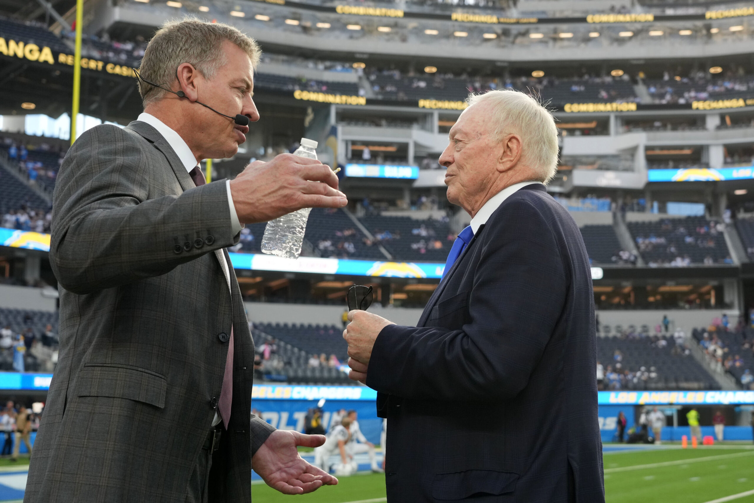 Dallas Cowboys owner Jerry Jones (right) talks with former quarterback Troy Aikman before the game against the Los Angeles Chargers at SoFi Stadium.