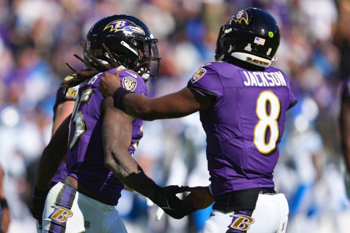 Baltimore Ravens RB Gus Edwards (35) and QB Lamar Jackson (8) celebrate a touchdown.