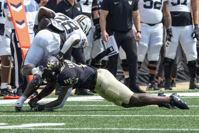 Vanderbilt Commodores running back Sedrick Alexander (28) is tackled by Wake Forest Demon Deacons defensive back Caelen Carson (1) during the second quarter at Allegacy Federal Credit Union Stadium.