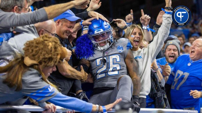 Detroit Lions running back Jahmyr Gibbs (26) jumps into the stands and celebrates his touchdown against the Las Vegas Raiders with the fans during the second half at Ford Field.