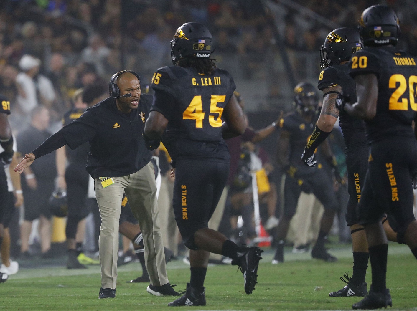 Arizona State's linebackers coach Antonio Pierce greets the defense after a stop against Michigan State.