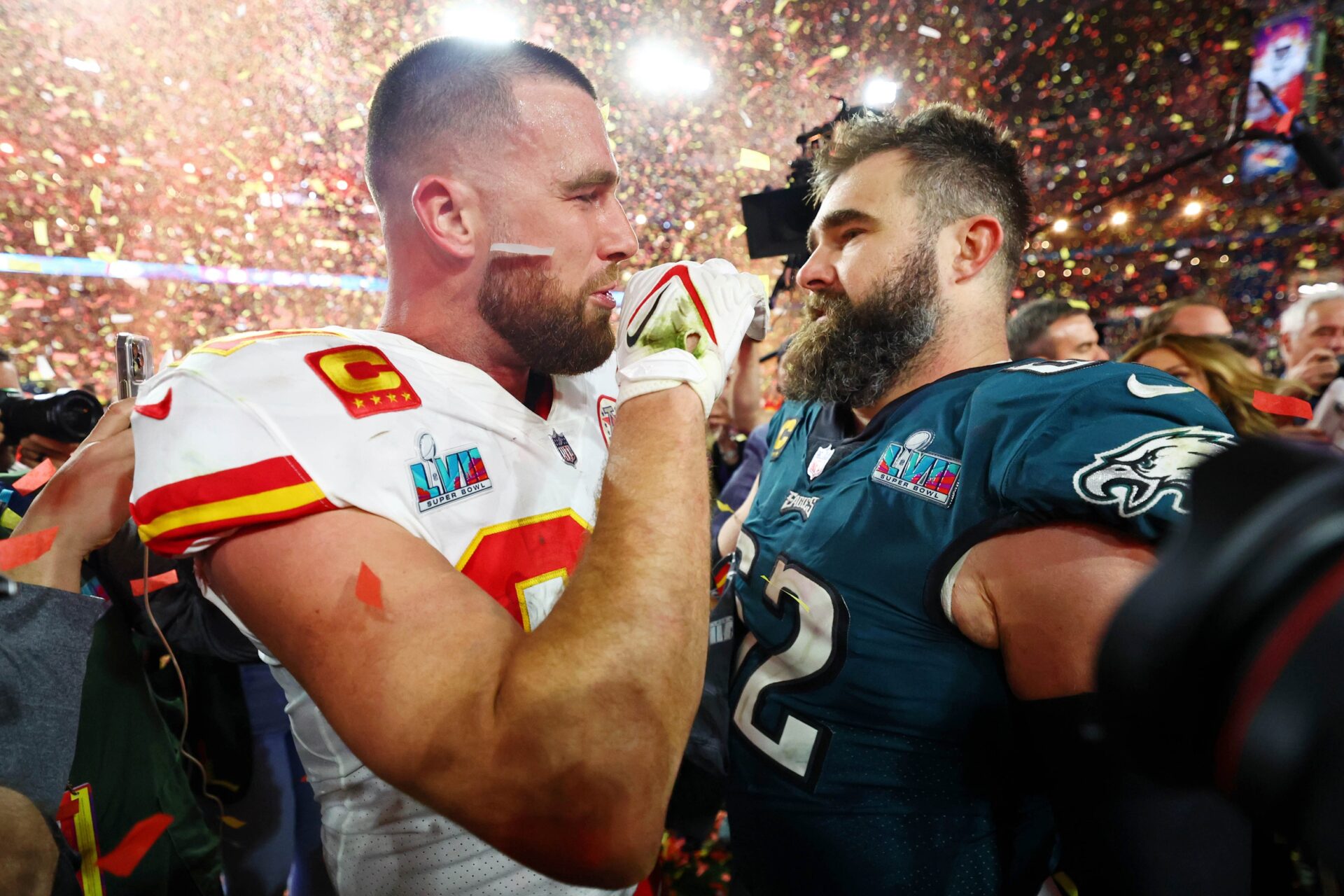 Kansas City Chiefs tight end Travis Kelce (87) talks with his brother Philadelphia Eagles center Jason Kelce (62) after he won Super Bowl LVII.