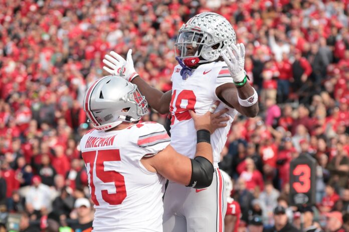 Ohio State Buckeyes wide receiver Marvin Harrison Jr. (18) celebrates with offensive lineman Carson Hinzman (75) after scoring touchdown against the Rutgers Scarlet Knights during the second half at SHI Stadium.
