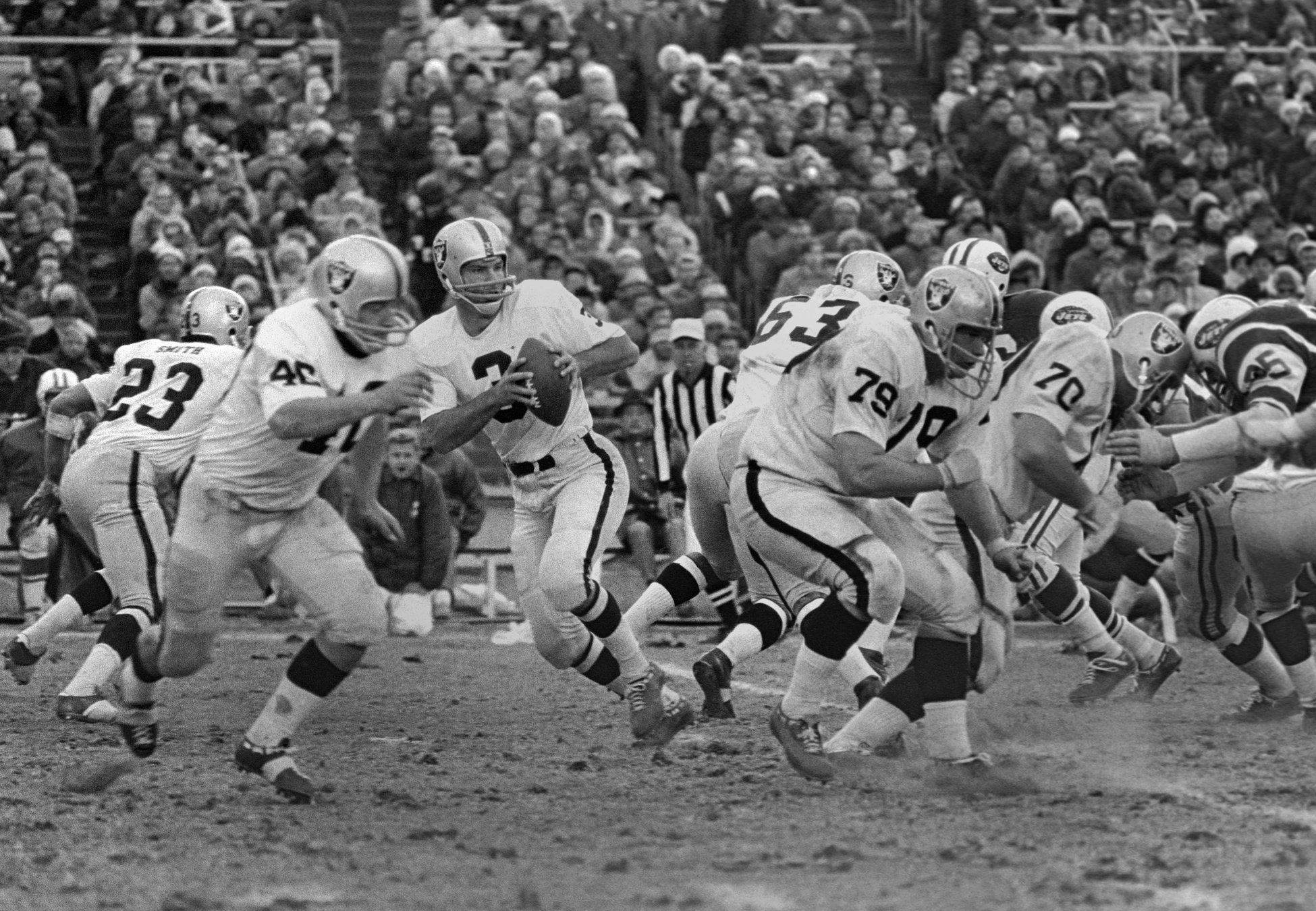 Oakland Raiders quarterback Daryle Lamonica (3) drops back to pass behind tackle Harry Schuh (79) against the New York Jets at Shea Stadium.