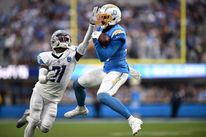 Los Angeles Chargers wide receiver Keenan Allen (13) makes a catch against Detroit Lions safety Kerby Joseph (31) )during the first half at SoFi Stadium.
