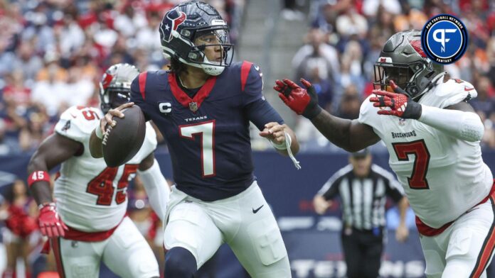 Houston Texans quarterback C.J. Stroud (7) looks for an open receiver as Tampa Bay Buccaneers linebacker Shaquil Barrett (7) applies defensive pressure during the first quarter at NRG Stadium.