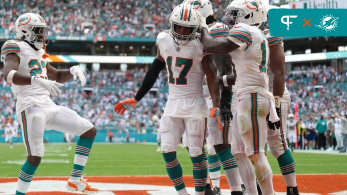 Miami Dolphins WR Jaylen Waddle (17) celebrates with teammates after a touchdown.