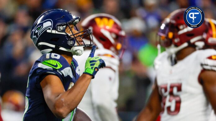 Seattle Seahawks wide receiver Tyler Lockett (16) reacts after catching a touchdown pass against the Washington Commanders during the fourth quarter at Lumen Field.