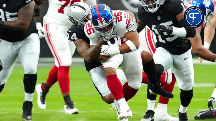 New York Giants running back Saquon Barkley (26) is tackled by Las Vegas Raiders cornerback Marcus Peters (24) during the first quarter at Allegiant Stadium.