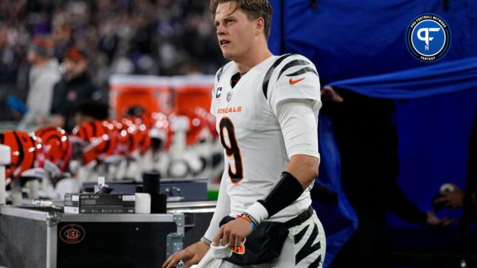 Cincinnati Bengals QB Joe Burrow (9) emerges from the examination tent before running to the locker room with an apparent hand injury.